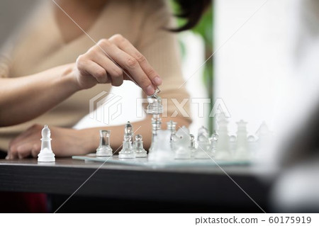Woman playing chess Woman playing chess 60175919