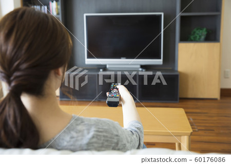 Female Young woman Housewife TV Living Dining Sofa Lifestyle Relax Smile Female Young woman Housewife TV Living Dining Sofa Lifestyle Relax Smile 60176086