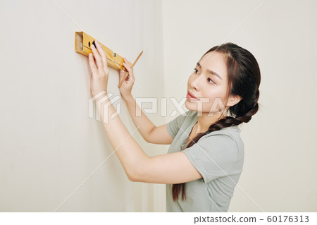 Woman renovating house 60176313