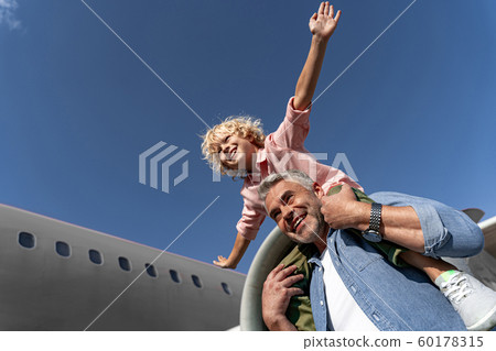 Happy little son and his father playing together Happy little son and his father playing together 60178315