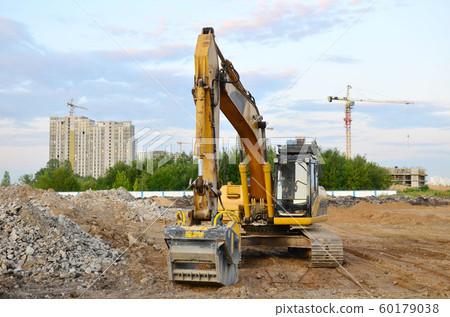 Excavator with crusher bucket for crushing concrete. Excavator with crusher bucket for crushing concrete. 60179038