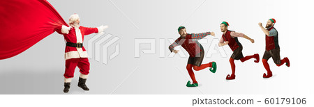 Emotional Santa Claus and his entourage greeting with New Year and Christmas 60179106