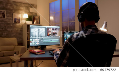 Back view of content creator working in home office Back view of content creator working in home office 60179722