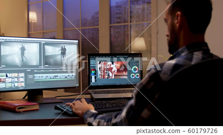 Back view of content creator working in home office 60179726