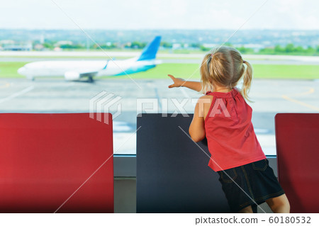Little kid wait for boarding to plane flight in 60180532