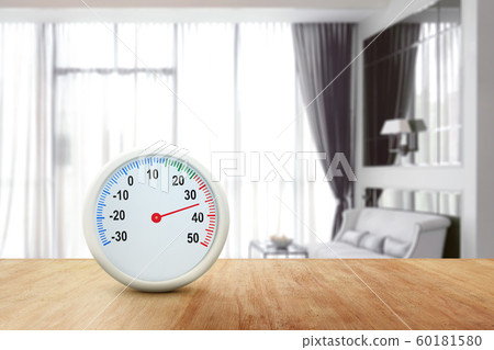 The thermometer on a wooden table measuring the temperature 60181580
