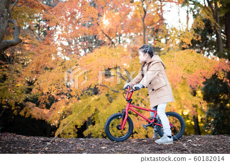 Girls enjoying autumn cycling Girls enjoying autumn cycling 60182014