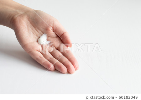 Young woman applying hand cream. Cold protection 60182049