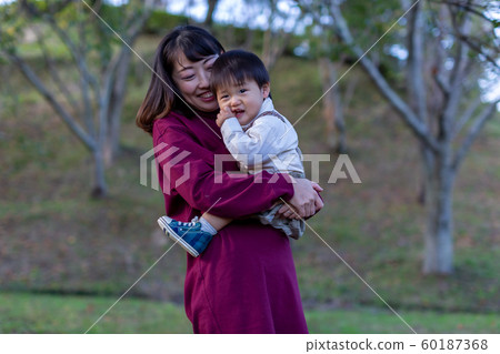 Parent and child playing in the park Parent and child playing in the park 60187368