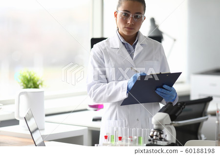 Focused researcher in light working room 60188198