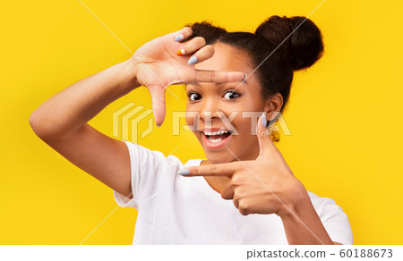 Portrait of afro teenager making frame with fingers 60188673