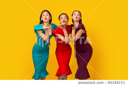 Three Diverse Girls In Dresses Sending Air Kiss, Studio Shot 60189151