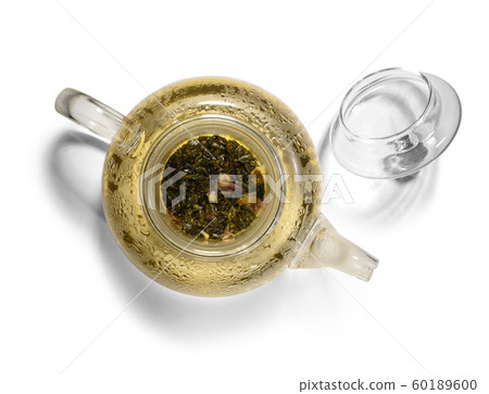 Hot green tea in glass teapot on white background Hot green tea in glass teapot on white background 60189600