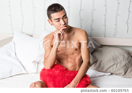Young handsome man rest in bed. Sexy naked guy is Young handsome man rest in bed. Sexy naked guy is 60189765
