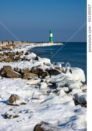 Mole in winter time in Warnemuende, Germany Mole in winter time in Warnemuende, Germany 60190007