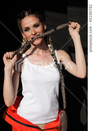 Beautiful fashionable woman with braids dancing break 60190782