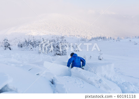A man covered with a snow avalanche A man covered with a snow avalanche 60191118