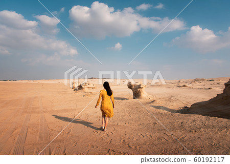 Female traveler visiting Fossil dunes in Abu Dhabi Female traveler visiting Fossil dunes in Abu Dhabi 60192117