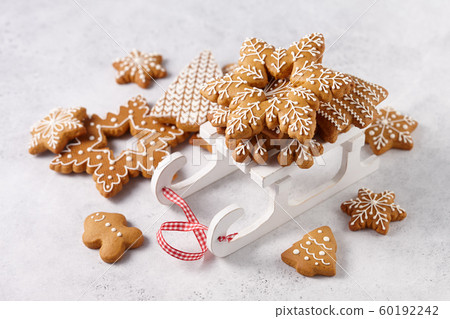 Gingerbread cookies on white wooden sledge 60192242