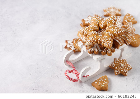 Gingerbread cookies on white wooden sledge 60192243