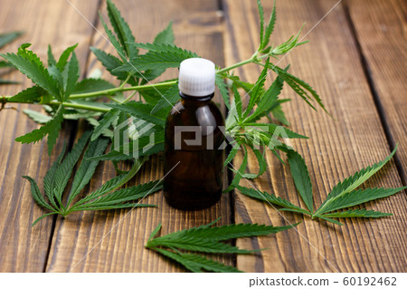 hemp oil on a wooden background. Marijuana 60192462