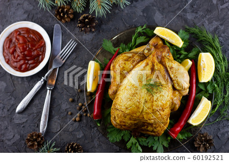 Fried whole chicken on a platter. Holiday lunch. Fried whole chicken on a platter. Holiday lunch. 60192521
