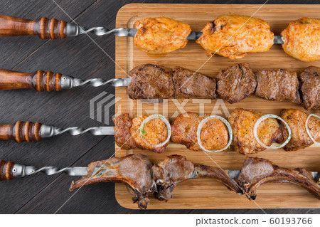 Assorted kebabs on the board. 60193766
