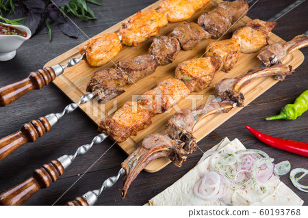 Assorted kebabs on the board. 60193768