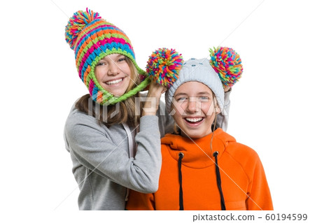 Close-up of winter portrait of attractive girl in knitted cap 12, 13 years old having fun, isolated on white background 60194599