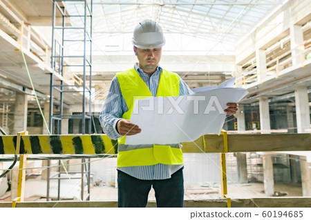 Portrait of male engineer at construction site. Building, development, teamwork and people concept 60194685