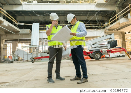 Group of engineers, builders, architects on the building site. Construction, development, teamwork and people concept Group of engineers, builders, architects on the building site. Construction, development, teamwork and people concept 60194772
