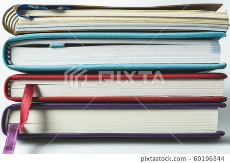 Close up stack of books on white background 60196844