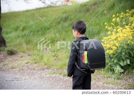 Elementary school boy going to school Elementary school boy going to school 60200613