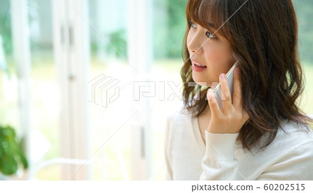Image of woman calling on smartphone Image of woman calling on smartphone 60202515