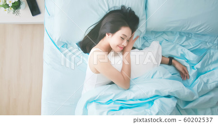woman sleeping well in bed 60202537