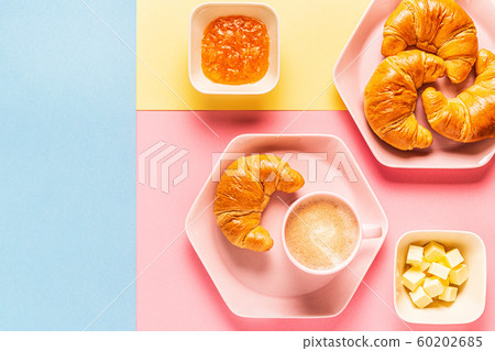Coffee and croissants on a bright trendy Coffee and croissants on a bright trendy 60202685