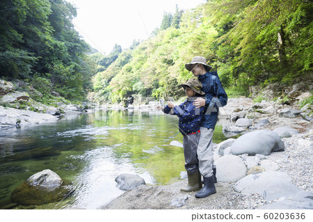 Mountain stream fishing image Parent and child family 60203636