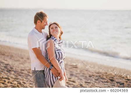 Happy couple in love relaxing at the beach. 60204369