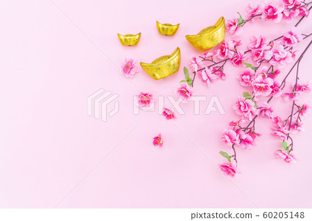 Flat lay Chinese lunar new year gold money and flower on pink background 60205148