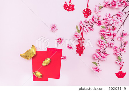 Flat lay Chinese lunar new year offering red envelope on pink background 60205149