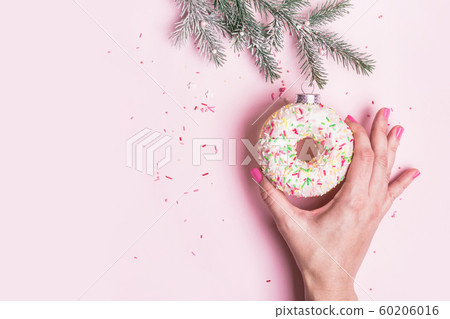 Female hand hangs Christmas bauble decoration made Female hand hangs Christmas bauble decoration made 60206016