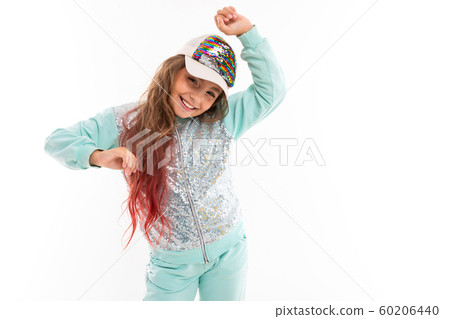 Little pretty caucasian girl in a tracksuit dancing, picture isolated on white background 60206440