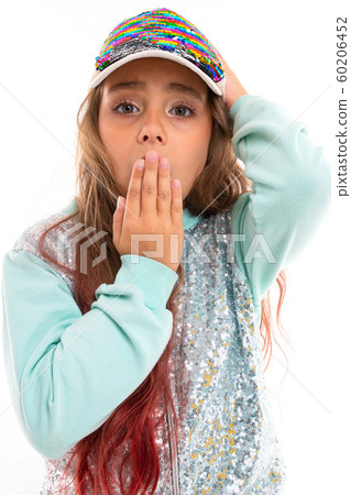 Little pretty caucasian girl in a tracksuit covers mouth with her hand, picture isolated on white Little pretty caucasian girl in a tracksuit covers mouth with her hand, picture isolated on white 60206452
