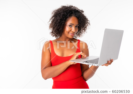 African female works with laptop and smiles, picture isolated on white background African female works with laptop and smiles, picture isolated on white background 60206530