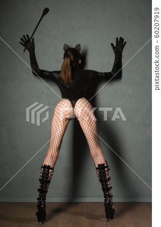 Adult sex games. Sexy girl in fishnet and leather 60207919