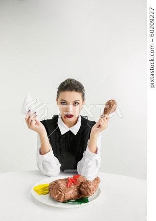 We are what we eat. Woman's eating plastic food, eco concept 60209227