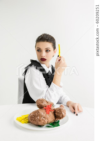 We are what we eat. Woman's eating plastic food, eco concept 60209251