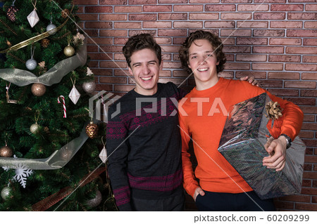 Two funny young men celebrating christmas over Two funny young men celebrating christmas over 60209299