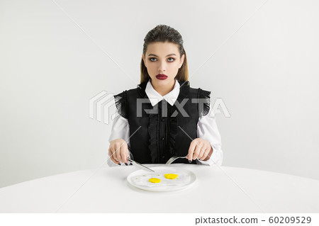 We are what we eat. Woman's eating plastic food, eco concept 60209529