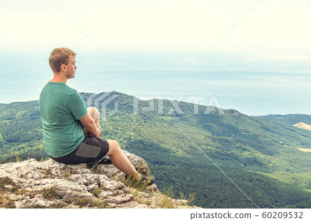 Young man practicing yoga pose sitting on the 60209532